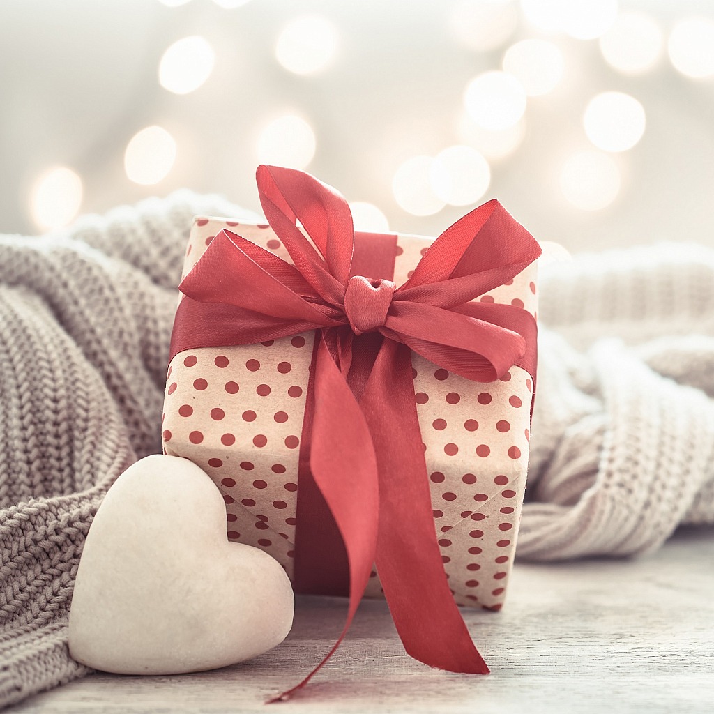 Background holiday, gift in a beautiful box with a heart .